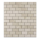 Close-up of Crema Marfil 2x4 polished mosaic showing beige veining