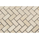 Close-up of Crema Marfil polished herringbone mosaic showing texture and veining