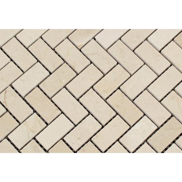 Close-up of Crema Marfil polished herringbone mosaic showing texture and veining