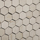 Close-up of polished Crema Marfil marble hexagon mosaic tile