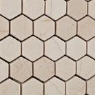 Close-up of tumbled 1 inch Crema Marfil marble hexagon mosaic