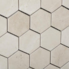 Close-up of polished 2 inch Crema Marfil marble hexagon mosaic tile