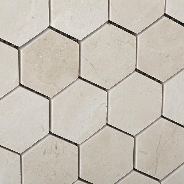 Close-up of polished 2 inch Crema Marfil marble hexagon mosaic tile