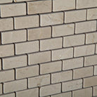 Close-up of polished Crema Marfil Mini Brick mosaic with natural veining