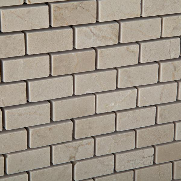 Close-up of polished Crema Marfil Mini Brick mosaic with natural veining