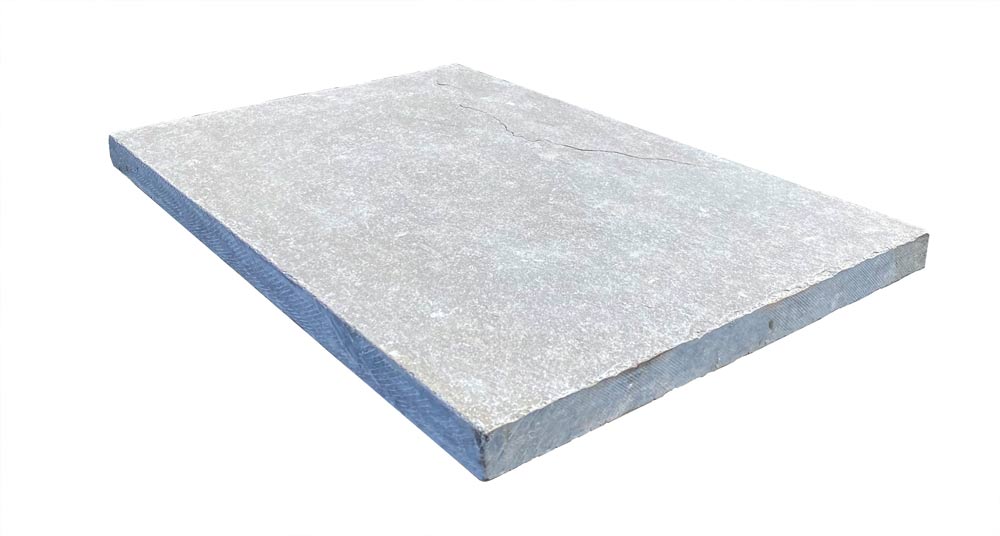 Close-up of Desert Blue Limestone showing textured tumbled surface and natural variation