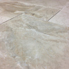 Close-up of Dina Royale Marble showing taupe veining and chiseled edges