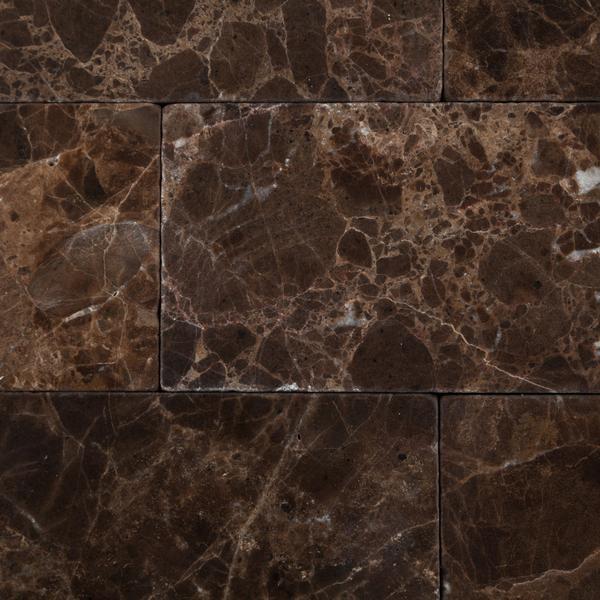 Close-up of Emperador Dark subway tile showing tumbled edges