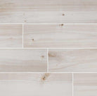 Flat lay of Havenwood Dove 8x36 wood-look porcelain tile in soft white tones with matte finish