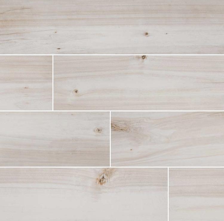 Flat lay of Havenwood Dove 8x36 wood-look porcelain tile in soft white tones with matte finish