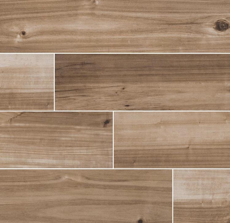 Flat lay of Havenwood Saddle 8x36 wood-look porcelain tile showing warm brown grain and matte finish