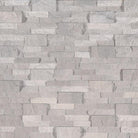 Flat lay of Iceland Gray travertine stacked stone panel in silvery gray tones