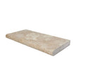 Close-up of Light Walnut Travertine showing natural movement and bullnose edge