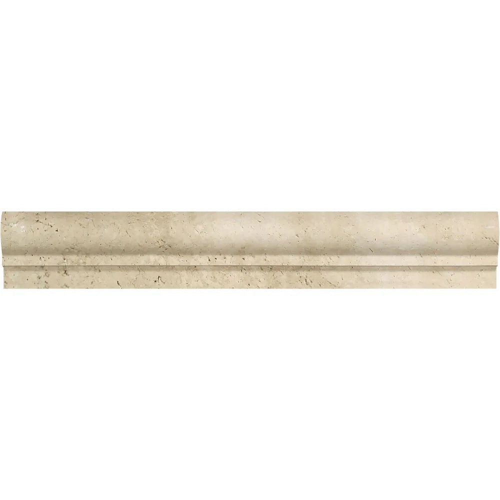 Close-up of Ivory Travertine chair rail molding showing curved profile and soft matte surface