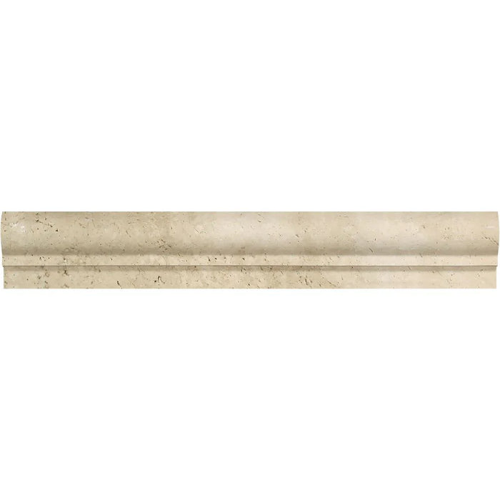 Close-up of Ivory Travertine chair rail molding showing curved profile and soft matte surface