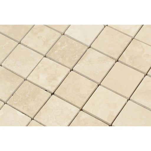 Close-up of Ivory Travertine 2x2 mosaic showing honed texture and warm tones