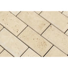 Close-up of Ivory Travertine 2x4 tiles showing deep bevel and warm tones
