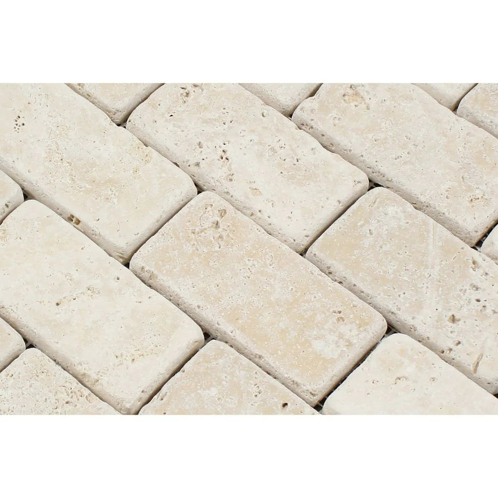Close-up of Ivory Travertine 2x4 Tumbled Mosaic showing tumbled texture and color variation