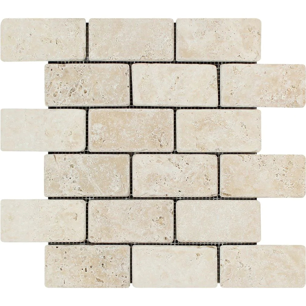 Flat view of Ivory Travertine 2x4 Tumbled Mosaic Tile on mesh sheet in cream and beige tones