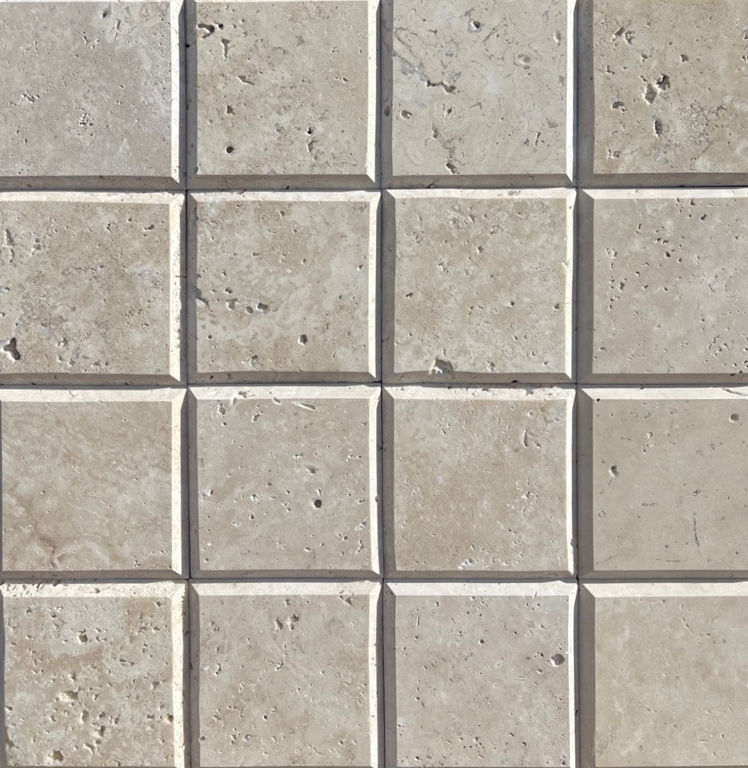 Close-up of Ivory Travertine 4x4 tile showing bevel depth and honed surface