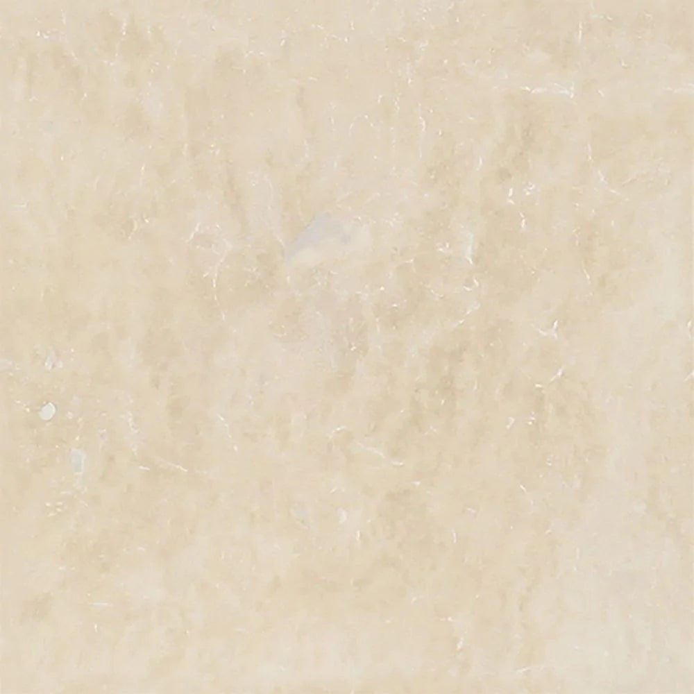 Close-up of Ivory Travertine 4x4 tile showing matte surface and subtle variation
