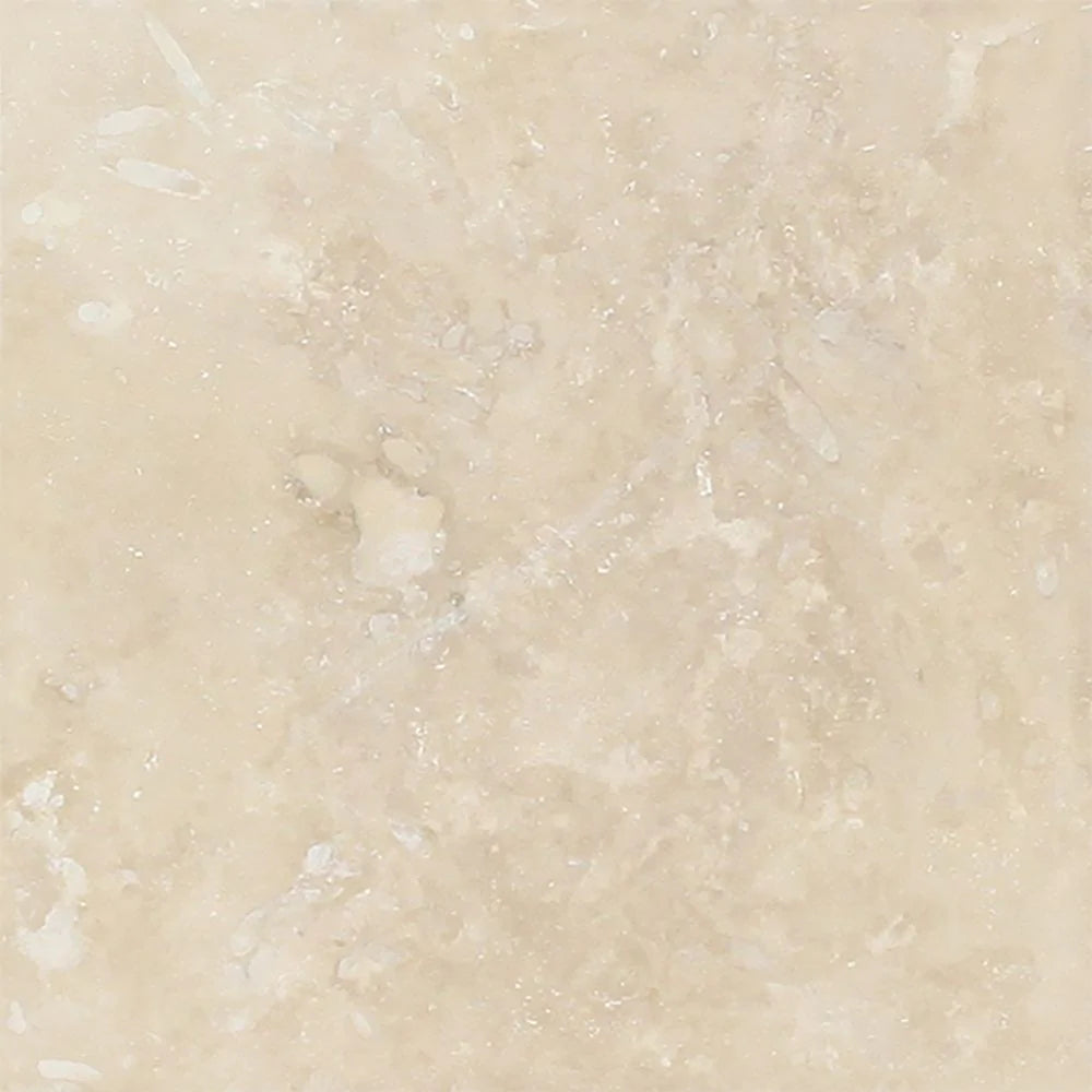 Close-up of Ivory Travertine 6x6 tile showing honed surface and cream-tan blend