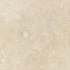 Close-up of Ivory Travertine 6x6 tile showing honed surface and cream-tan blend