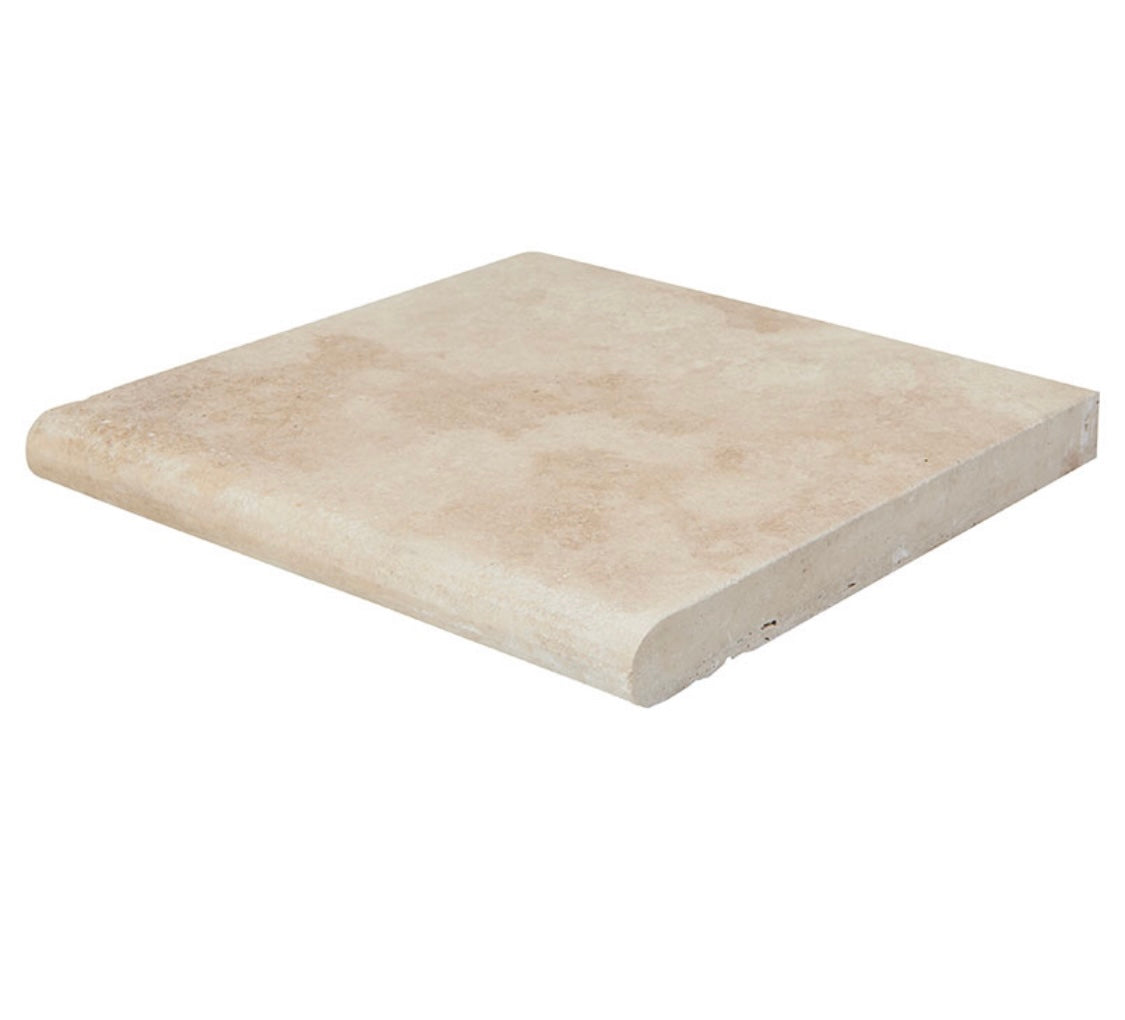 Close-up of Ivory Travertine showing bullnose edge and wispy beige pattern