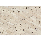 Close-up of tumbled travertine random strip mosaic showing varied lengths