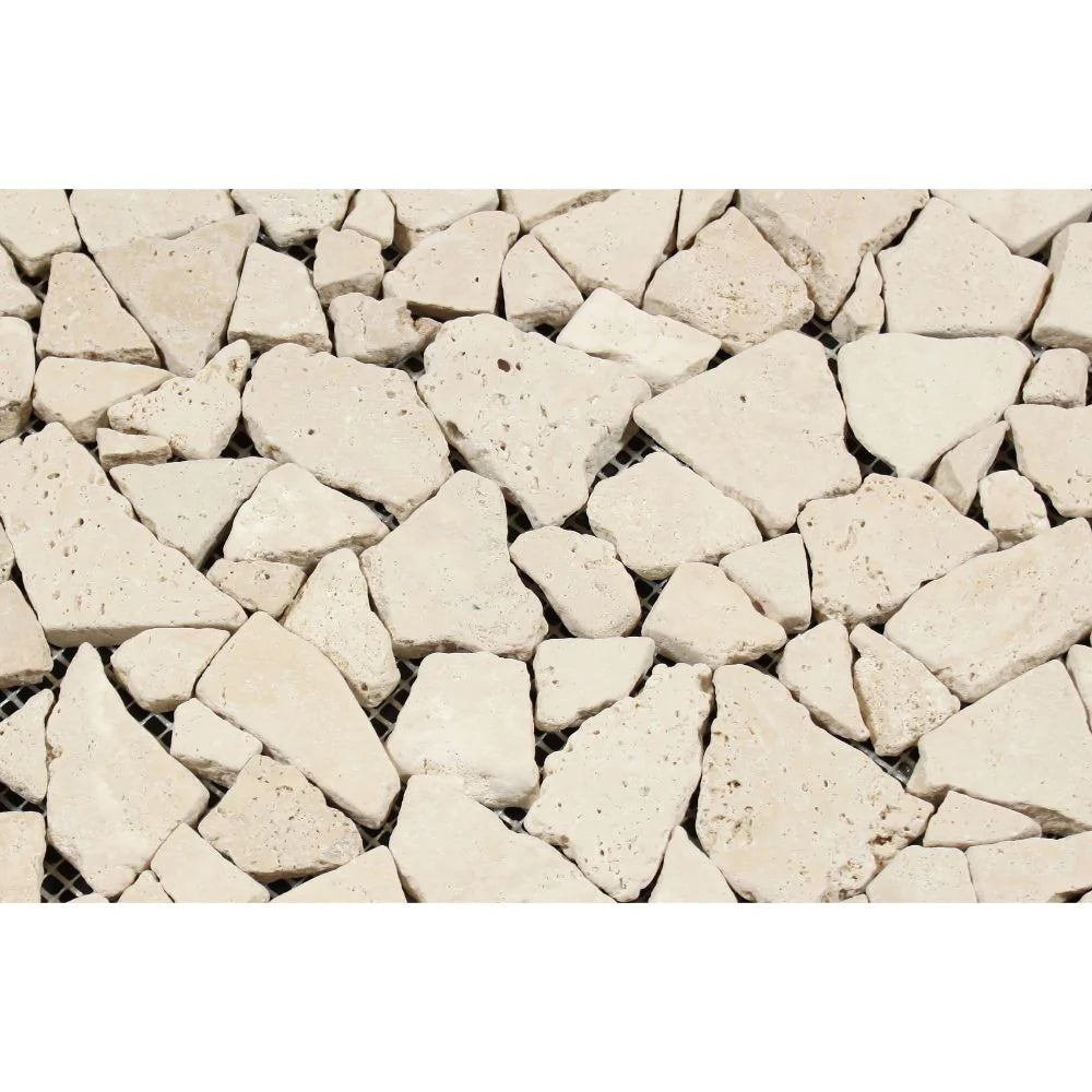 Close-up of irregular tumbled travertine pieces in random mosaic format