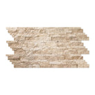Close-up of splitface finish showing raw travertine surface and cream-tan color