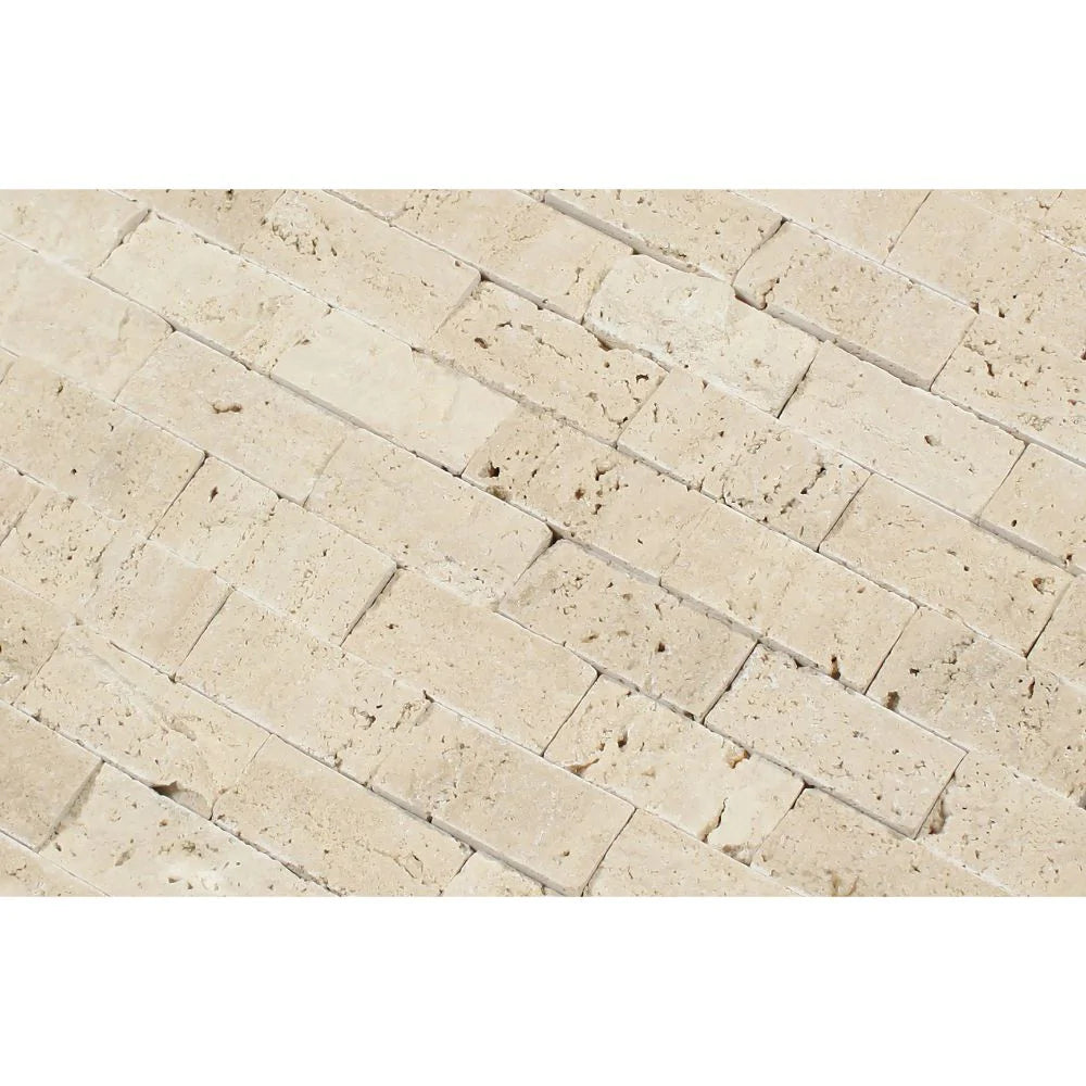 Close-up of 1x2 splitface travertine showing natural texture and cream-tan tones