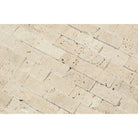 Close-up of 1x2 splitface travertine showing natural texture and cream-tan tones