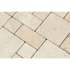 Close-up of tumbled mini pattern mosaic with beige and cream travertine tiles