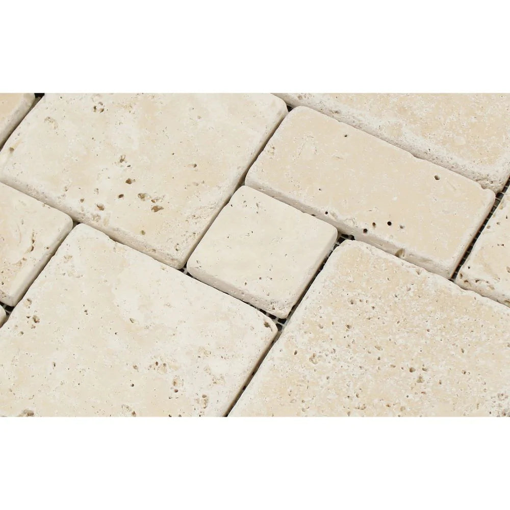 Close-up of tumbled travertine Opus pattern mosaic in ivory and beige
