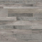 Flat lay of Mezcla Luxury Vinyl Tile showing soft gray and greige tones with realistic wood grain