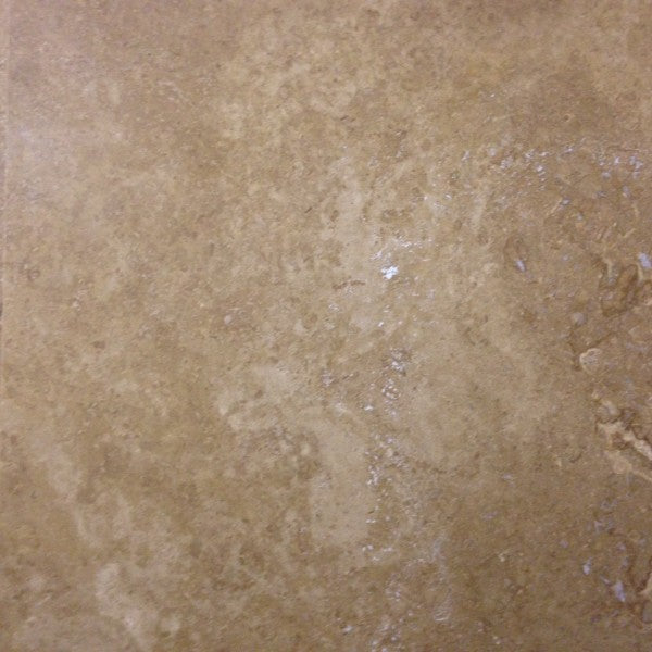 Flat lay of Noce Travertine honed and filled tile showing chocolate brown tones