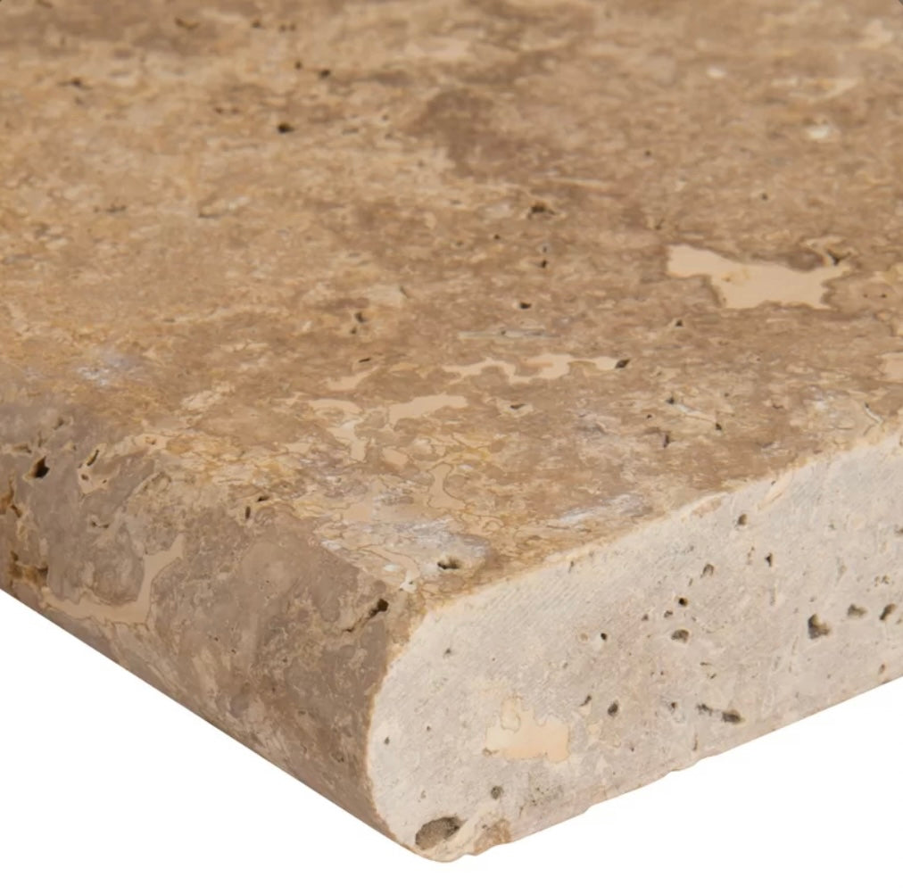 Close-up of Noche Travertine showing rich walnut tones and bullnose edge