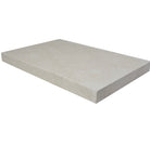 Close-up of Pearl Limestone showing clean modern edge and soft speckled surface