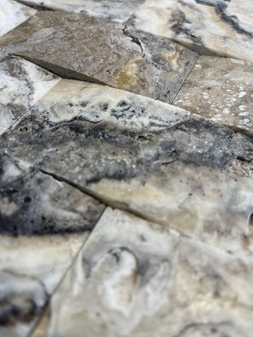 Detail of tumbled arched travertine in soft cream and gray tones