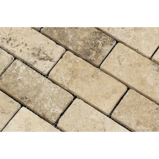 Detailed view of tumbled finish on 2x4 travertine brick mosaic