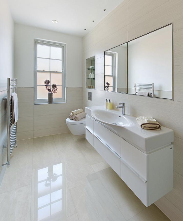 Close-up detail of Praia Grey polished porcelain tile showing fine gray veining