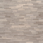 Close-up of textured honed marble surface with soft gray tones