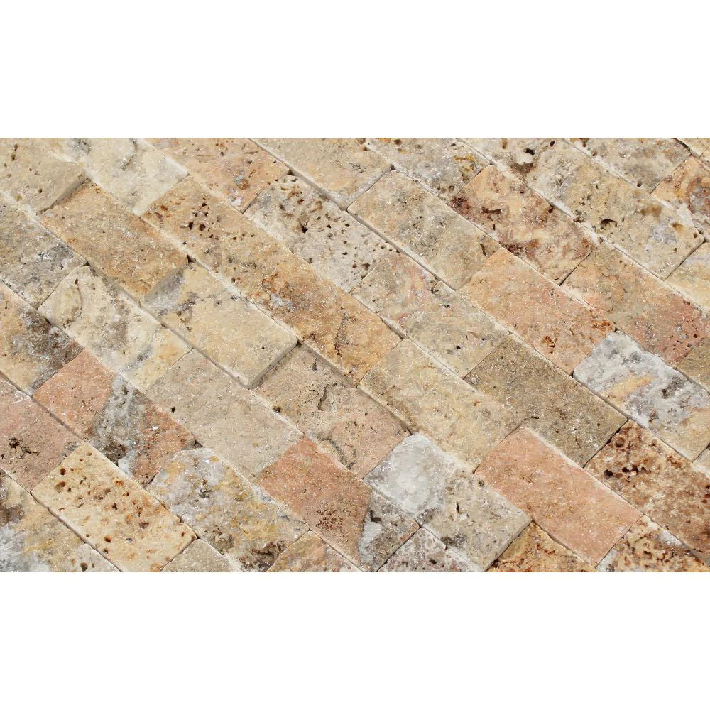 Detail view of 1x2 split face Scabos Travertine showing red, gold, and cream tones