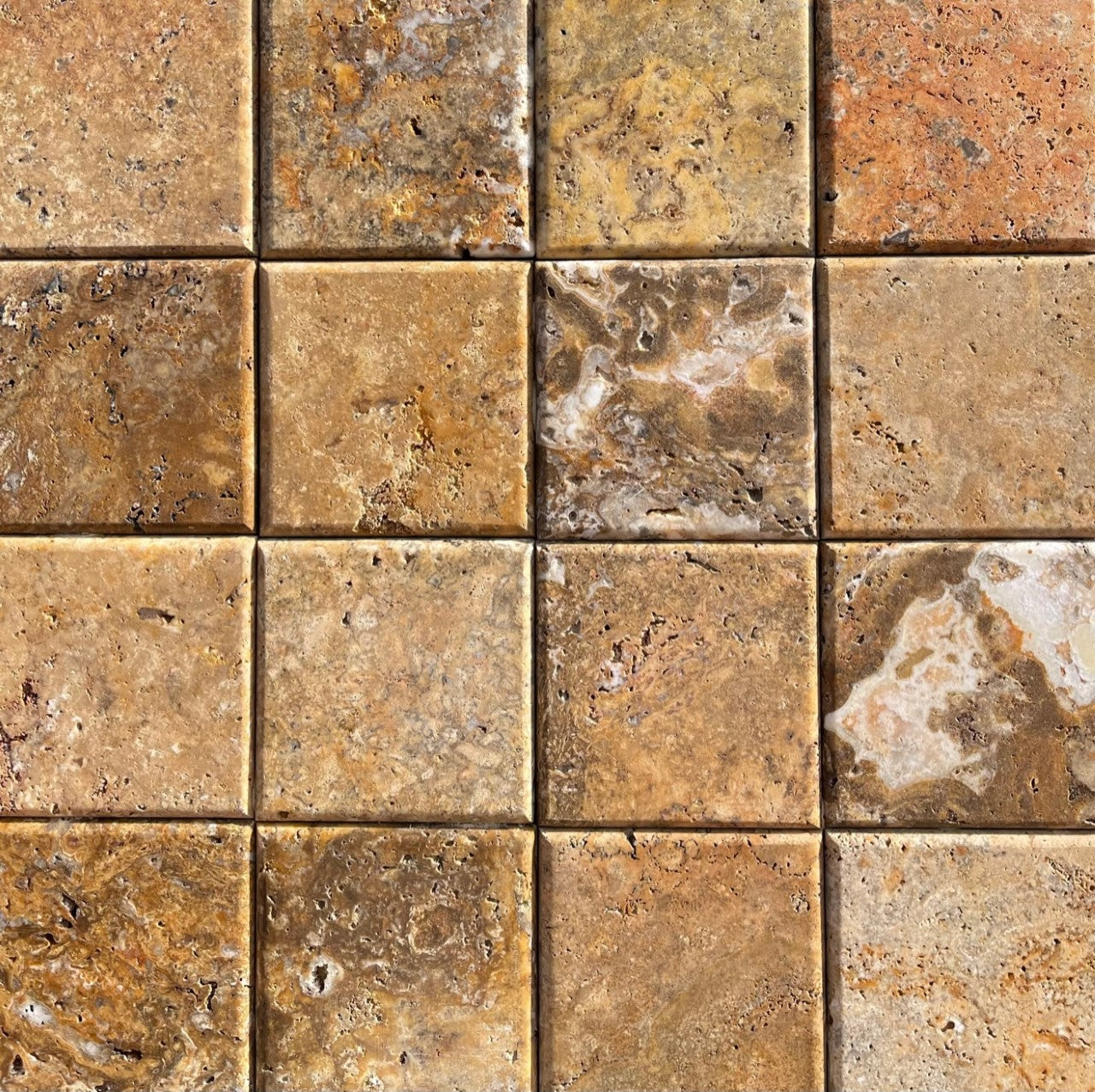Flat view of Scabos Travertine 4x4 tile with honed unfilled surface and rounded edge