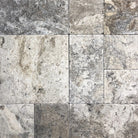 Close-up of Silver Mini Travertine Paver showing tumbled texture and color blend

