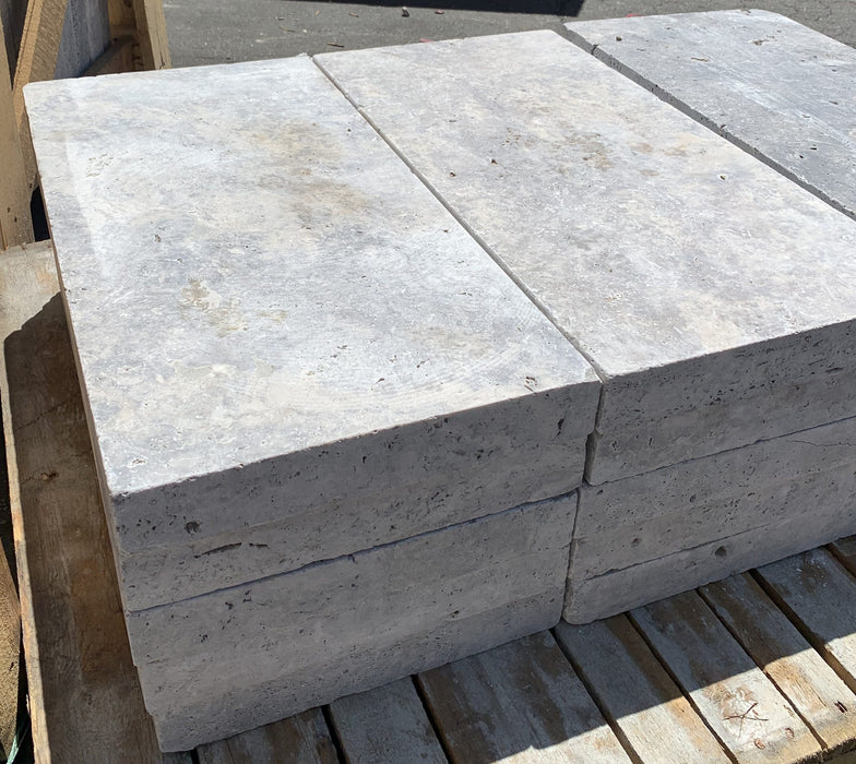 Close-up of 2" thick Silver Travertine Coping showing smooth edge and natural color