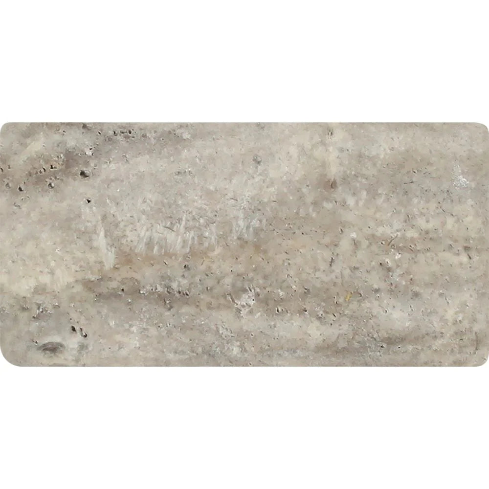 Close-up of 3x6 Silver Travertine showing rounded tumbled edges and textured surface