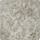 Close-up of Silver Travertine 4x4 tile with tumbled edge and textured surface