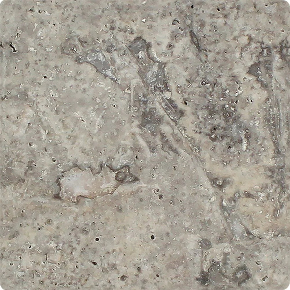 Close-up of 6x6 Silver Travertine tile showing tumbled texture and rounded edges